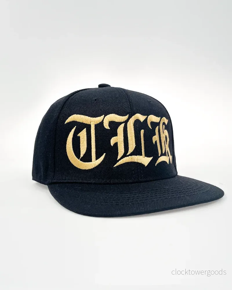 TLK Snapback – Svart/Guld TLK Snapback – Svart/Guld